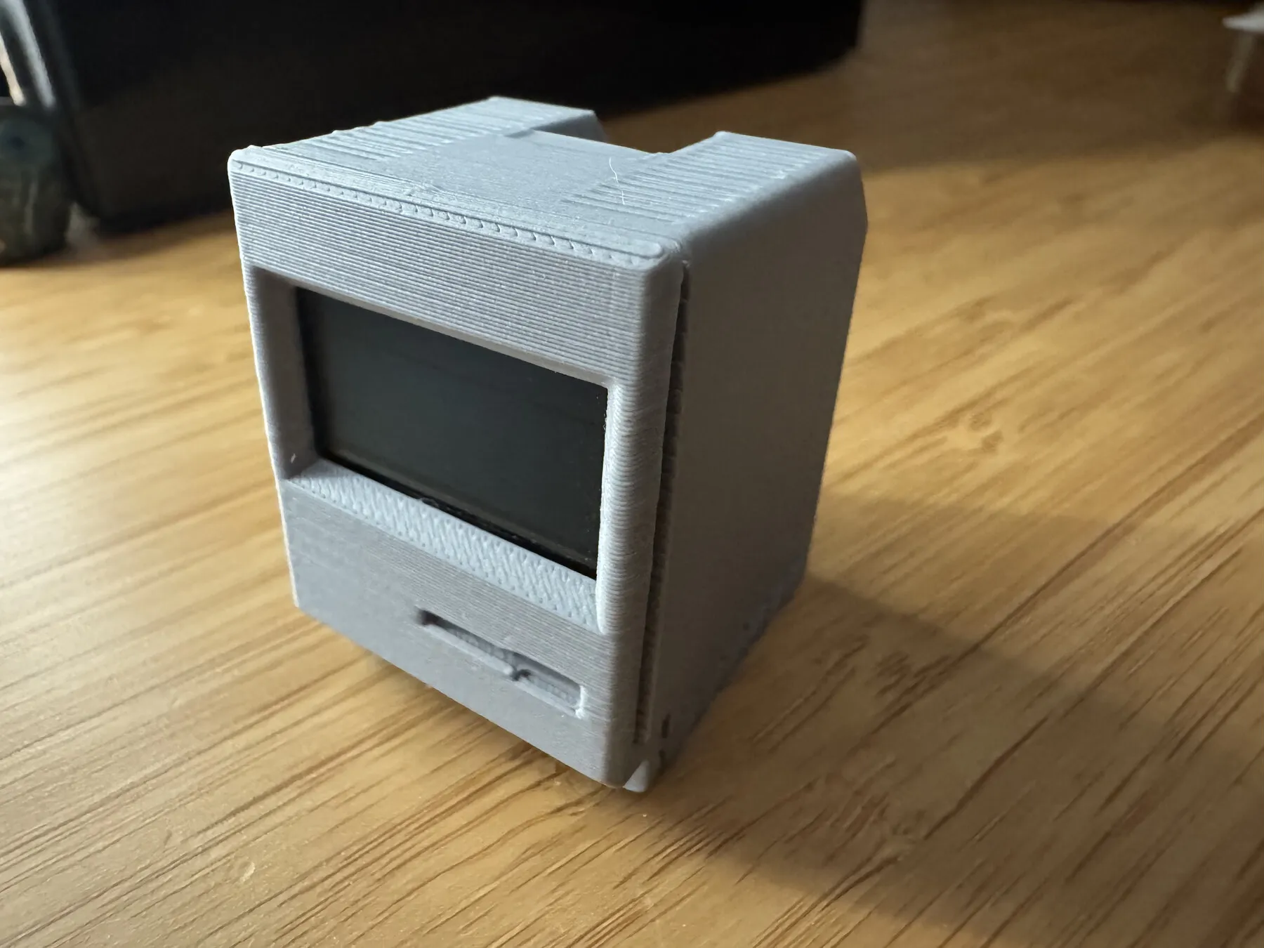 Five assembled Notificator devices with OLED screens and 3D-printed enclosures in different colours